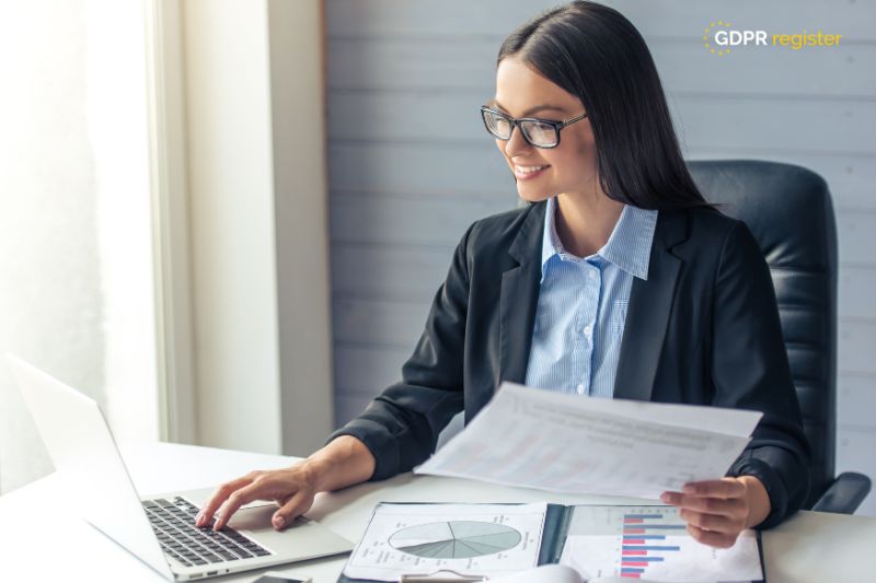 Businesswoman reviewing data charts on a laptop, illustrating GDPR data mapping for compliance.