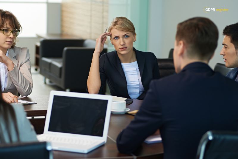 Business professionals discussing strategies, reflecting the importance of collaboration in a guide to developing a data breach response plan